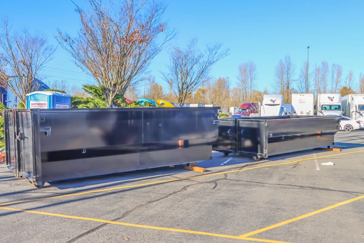 Professional dumpster rental service with roll-off container on residential driveway in Opelousas